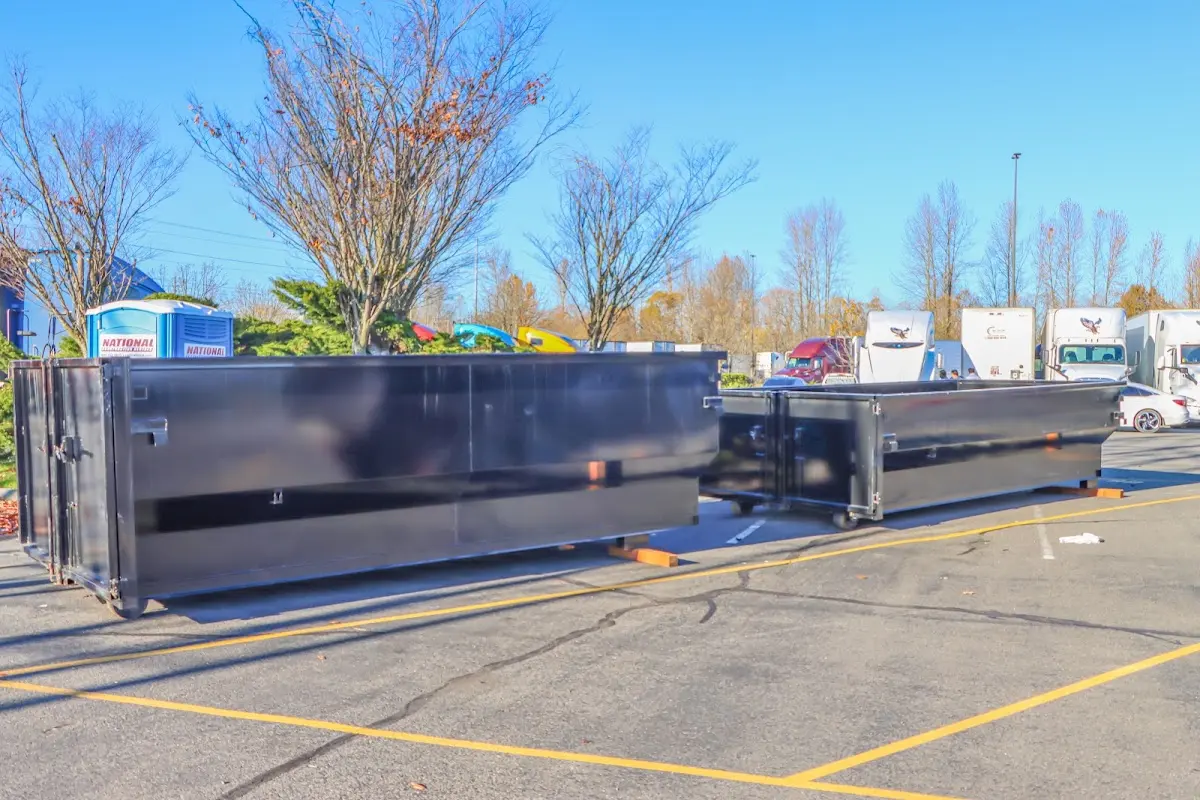 Professional dumpster rental service with roll-off container on residential driveway in Hidalgo